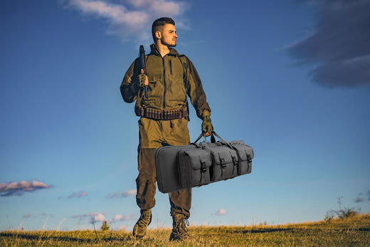 Person walking through a forest with a rifle bag strapped to their back